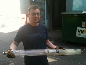 Richard is wearing safety gloves. Weeks after it has last been fired and it is still hot from residual laser radiation.